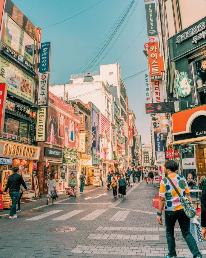 people walking on road surrounded by buildings