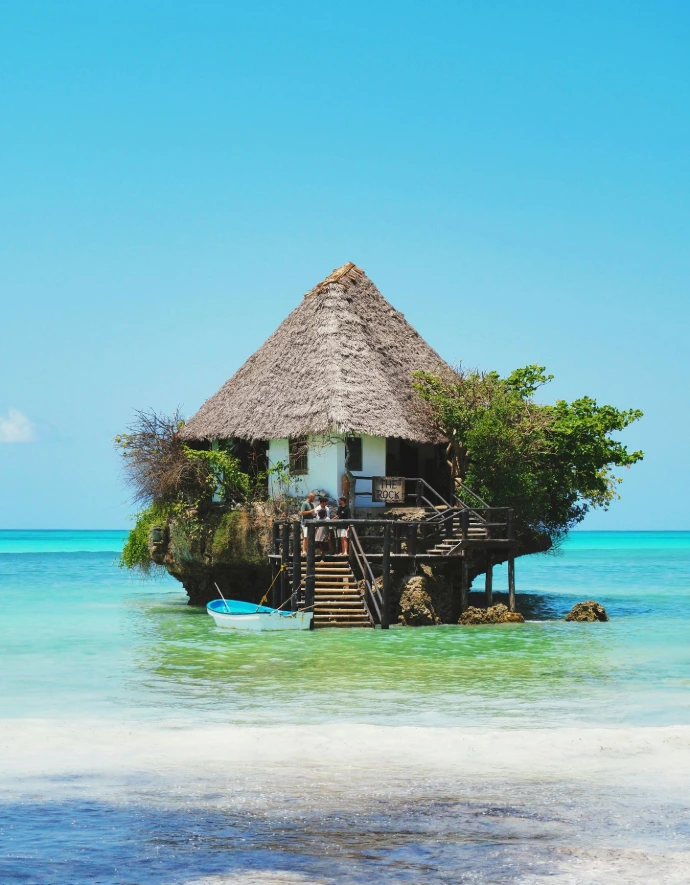 A hut on a small island in the middle of the ocean